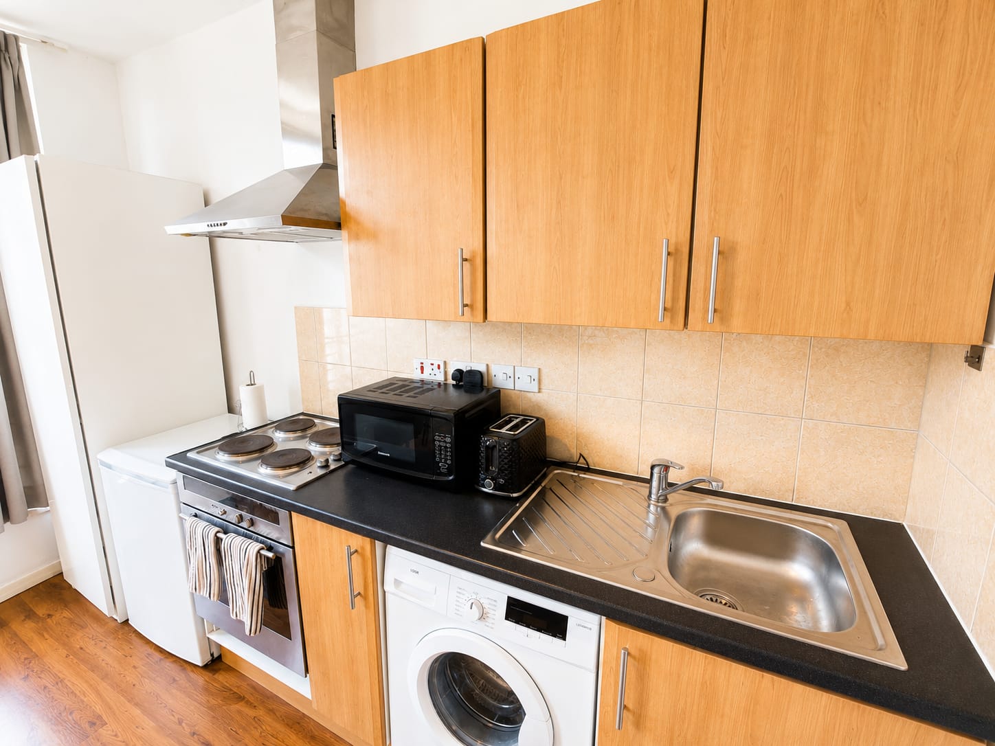Kitchen with microwave, kettle and washing machine