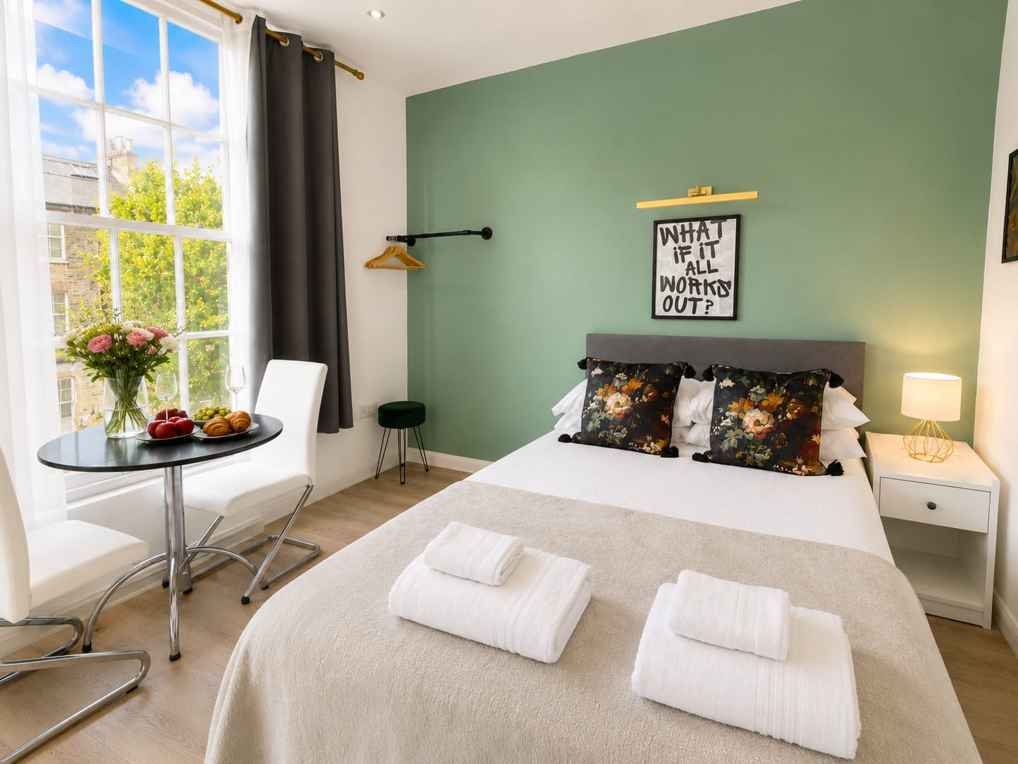 Bright view of the Islington Retreat with green accent wall and double bed