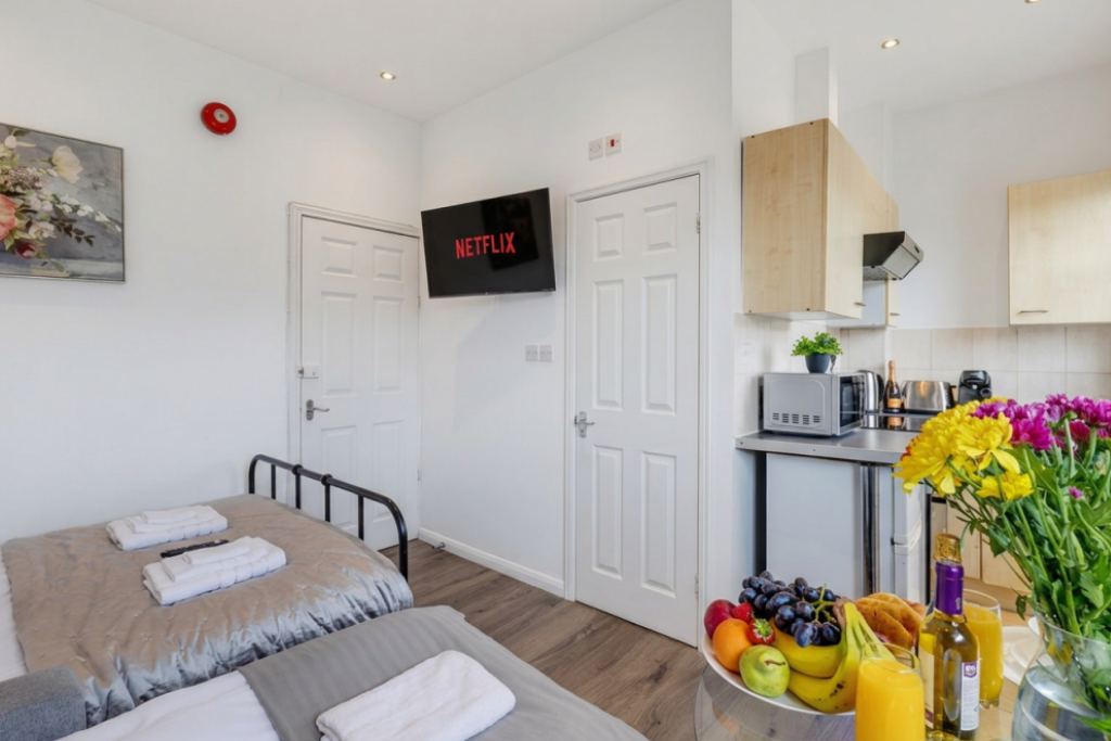 Smart TV with streaming apps and kitchenette in the studio
