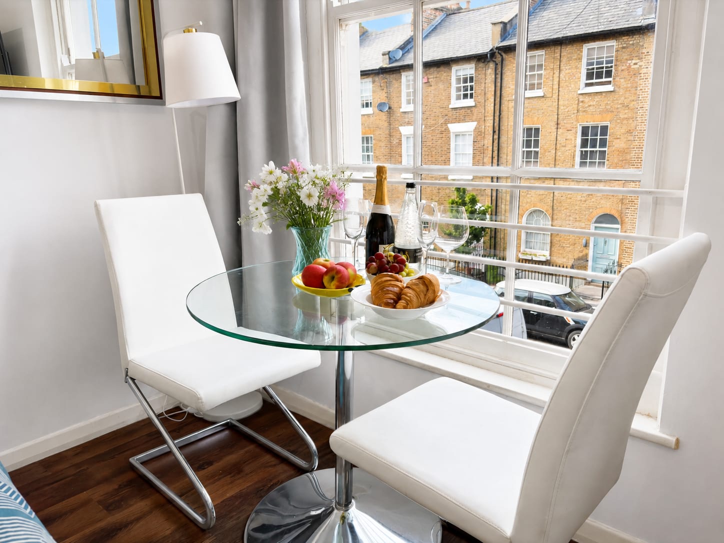Glass dining table for two with street views of Islington