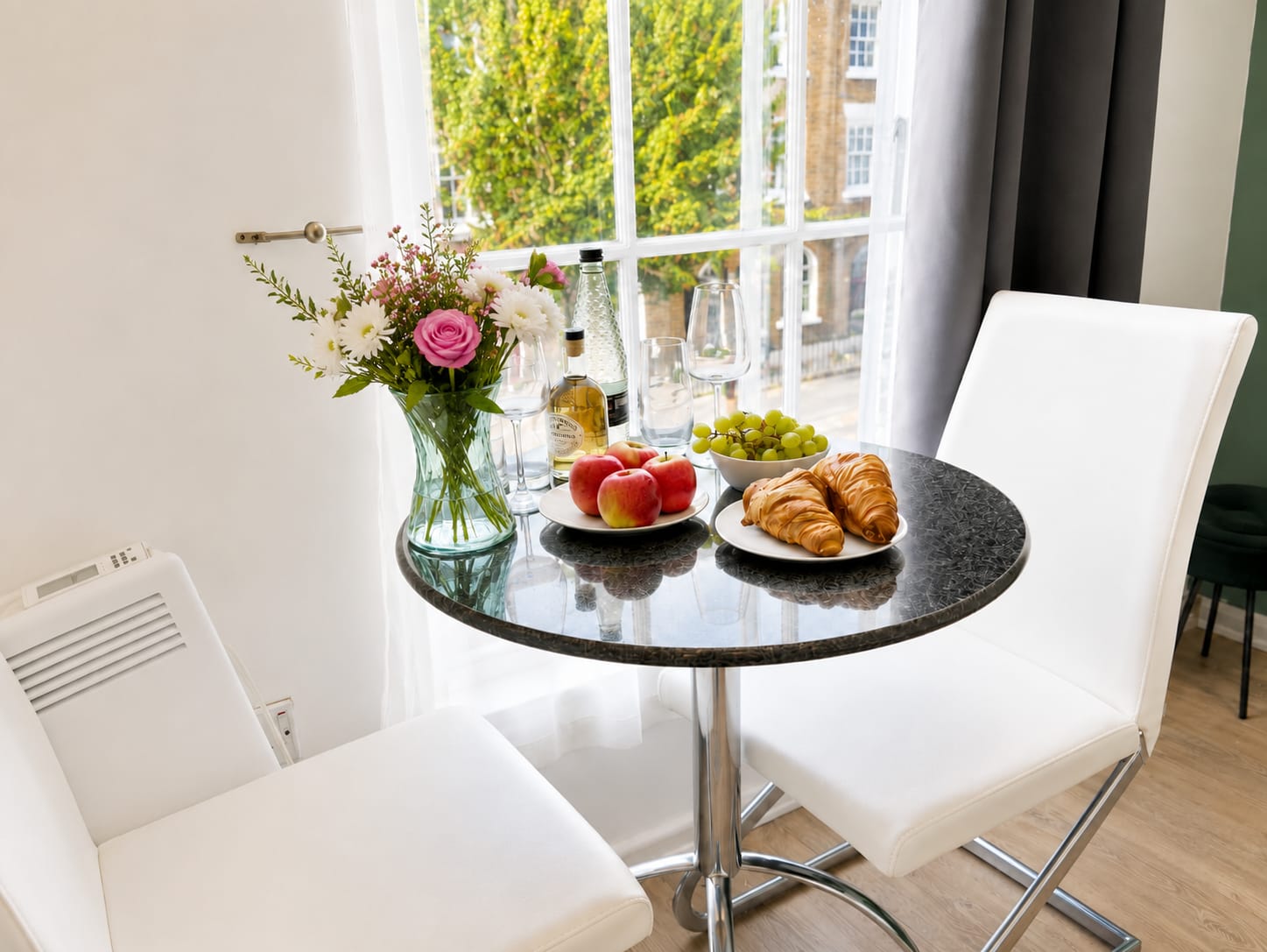 Round dining table set for two in the studio window light