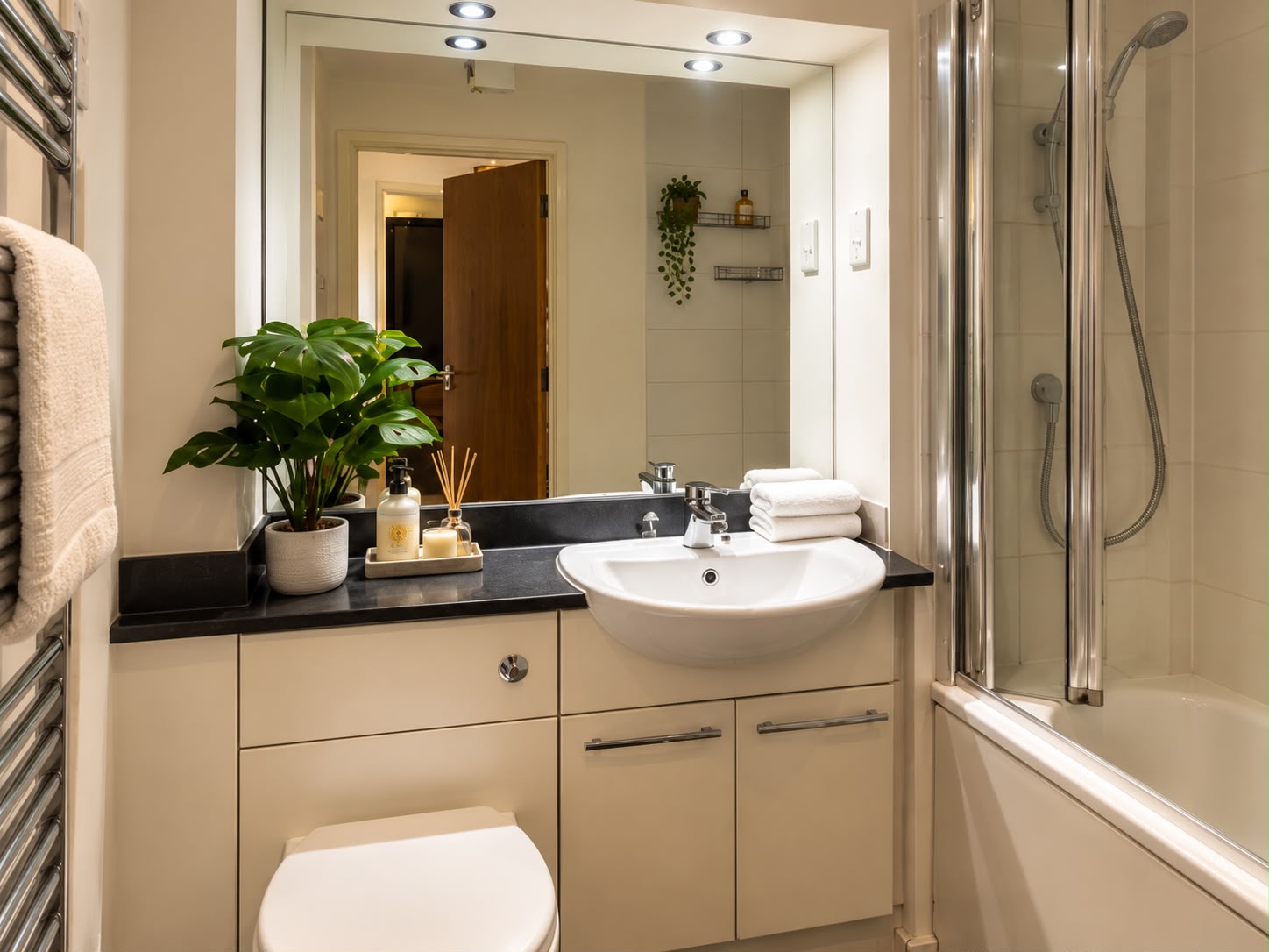 Bathroom with bathtub, overhead shower and vanity basin