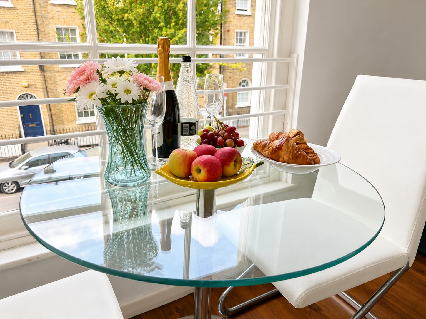 Dining table set with breakfast beside the window