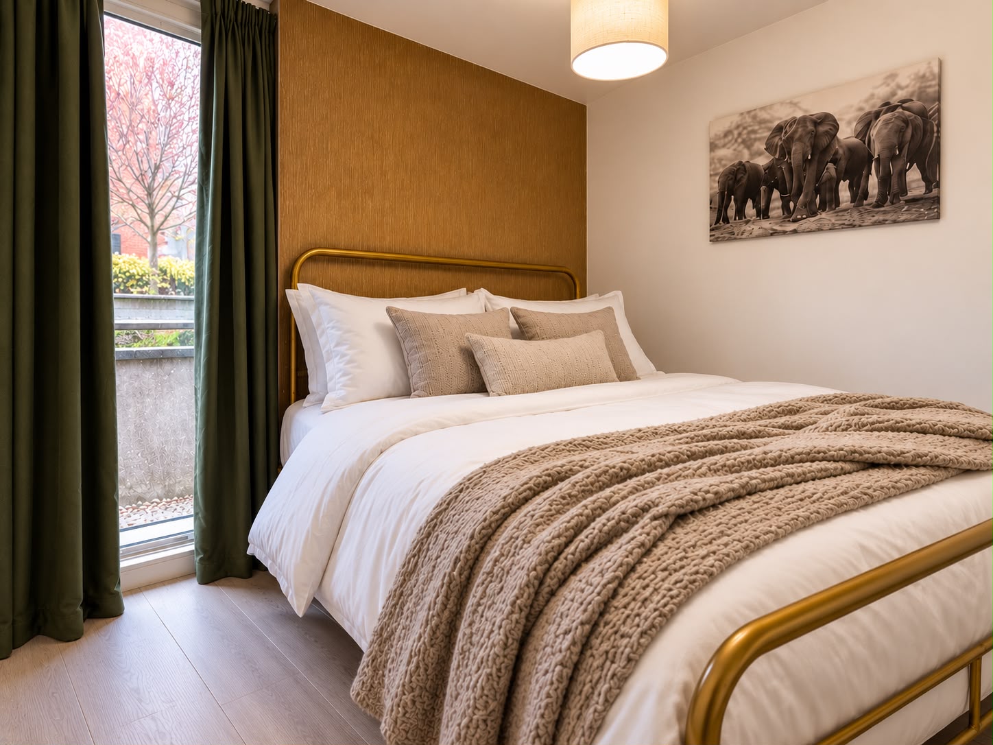 Bed and full-height window with olive-green curtains
