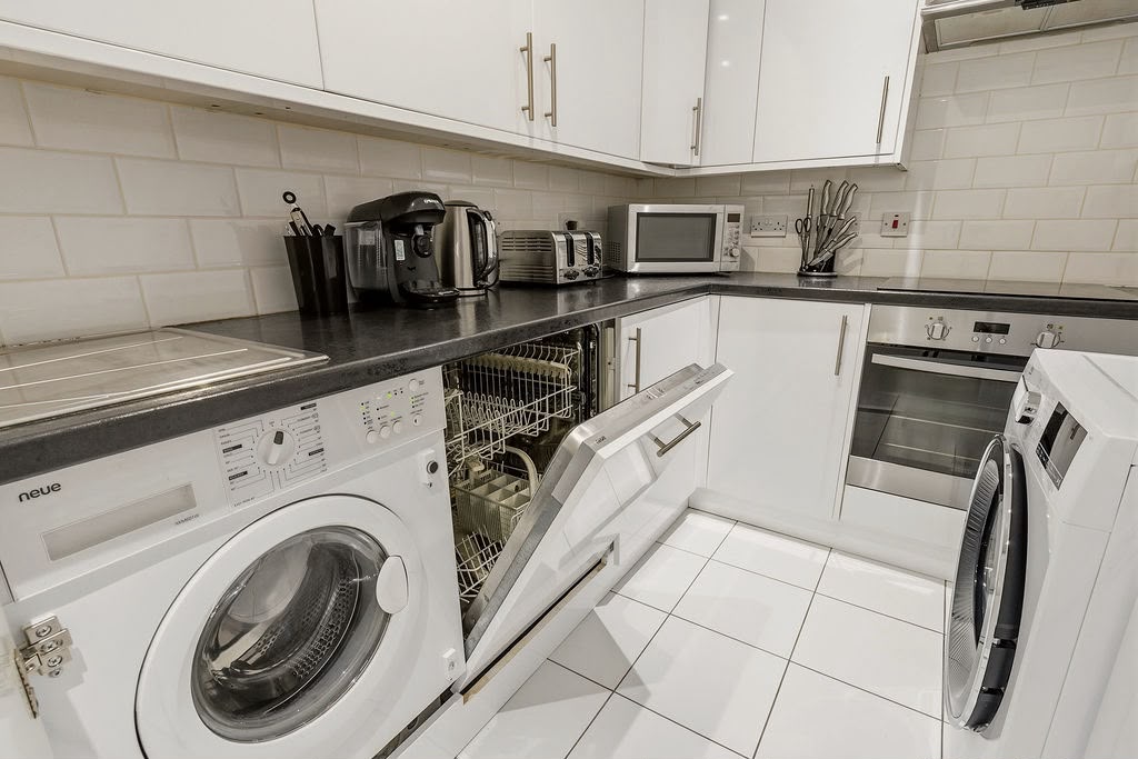 Kitchen with dishwasher, washing machine, coffee machine and full cookware